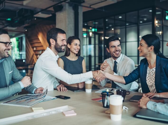 Group of people in a meeting around a table.