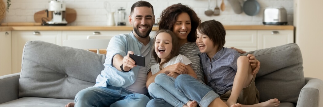 Family of four taking a picture together